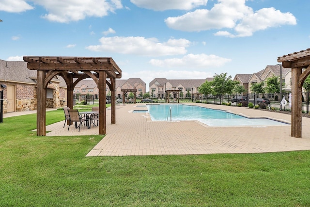 community pool with a residential view, a patio, fence, a yard, and a pergola