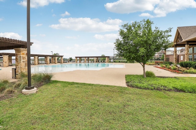 pool with a lawn and a patio