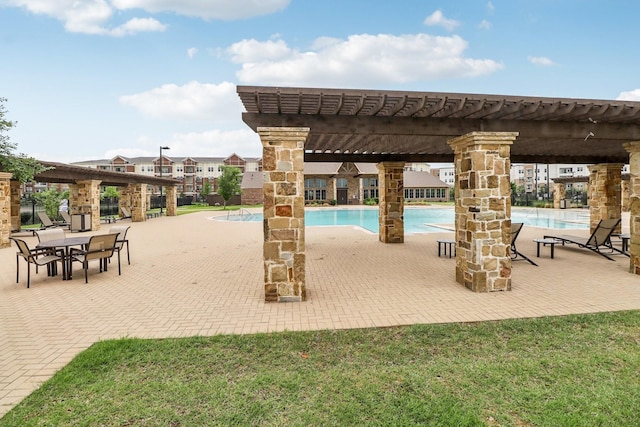 community pool featuring a pergola and a patio area