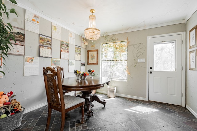 dining space featuring stone tile floors, baseboards, a notable chandelier, and ornamental molding