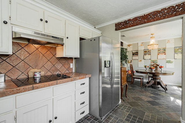 kitchen featuring crown molding, black electric stovetop, white cabinetry, under cabinet range hood, and stainless steel fridge with ice dispenser