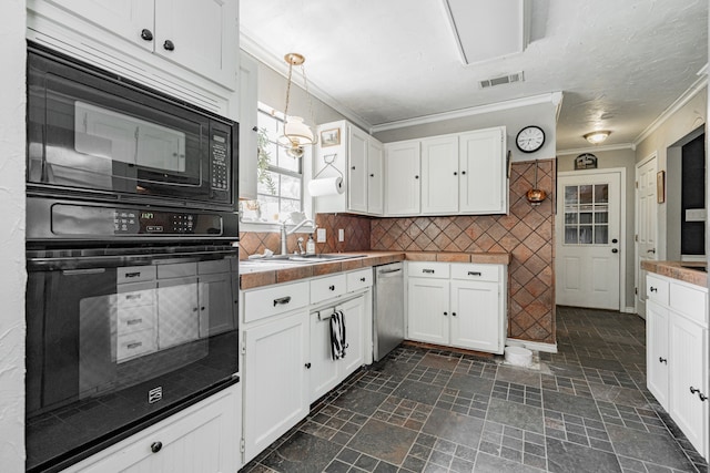 kitchen featuring visible vents, crown molding, white cabinets, a sink, and black appliances