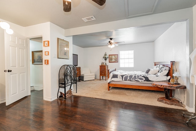 bedroom featuring baseboards, hardwood / wood-style floors, and visible vents