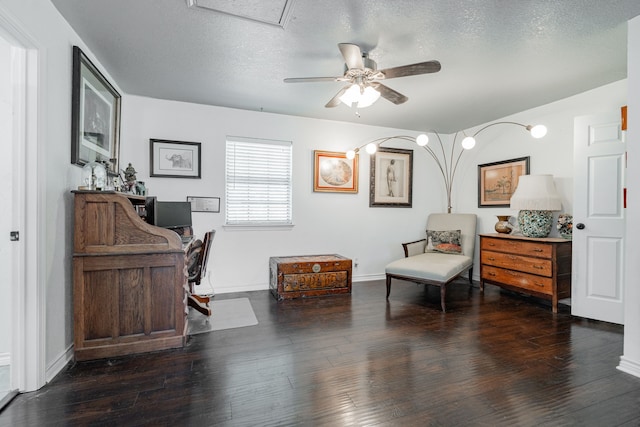 living area featuring baseboards, a textured ceiling, ceiling fan, and hardwood / wood-style floors