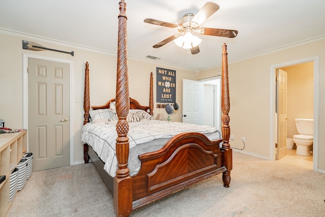 carpeted bedroom featuring crown molding, ensuite bath, a ceiling fan, baseboards, and visible vents