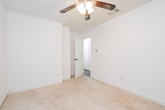 unfurnished room featuring visible vents, a ceiling fan, baseboards, and light carpet