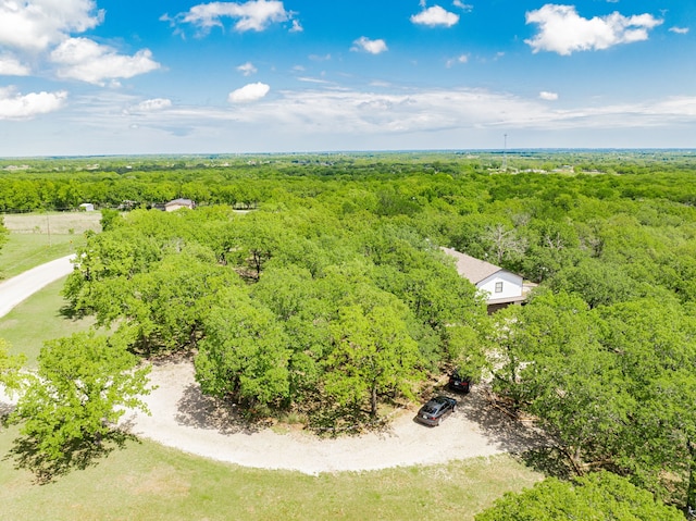 birds eye view of property featuring a view of trees