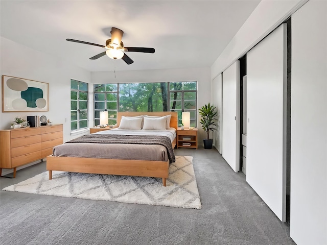 carpeted bedroom featuring a closet and ceiling fan