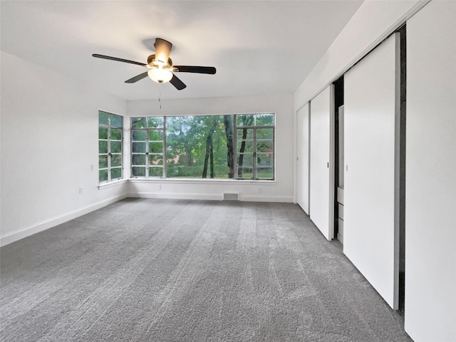 unfurnished bedroom with visible vents, a ceiling fan, a closet, baseboards, and carpet flooring