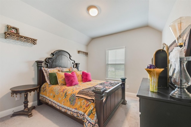 bedroom featuring baseboards, light carpet, and lofted ceiling