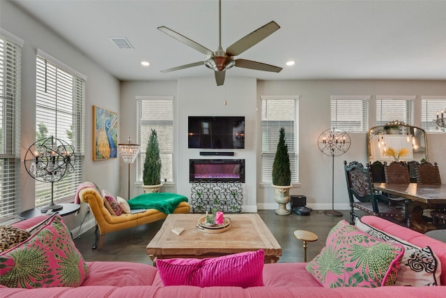living area with visible vents, recessed lighting, baseboards, and ceiling fan with notable chandelier