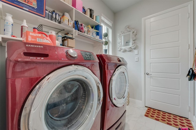 laundry area featuring separate washer and dryer, laundry area, and marble finish floor