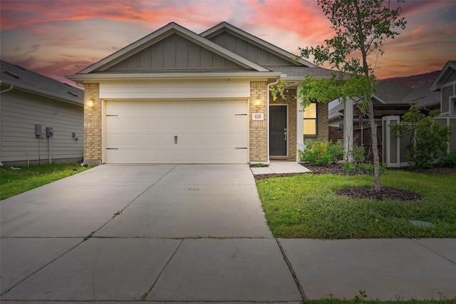 628 Coleman St, Aubrey, TX 76227 - view of front of home with a lawn, brick siding, board and batten siding, an attached garage, and driveway