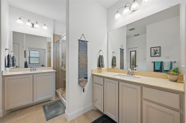 628 Coleman St, Aubrey, TX 76227 - full bathroom featuring two vanities, a sink, tile patterned flooring, and a stall shower