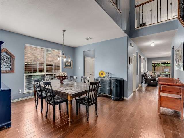 5732 Chateau Dr, Sachse, TX 75048 - dining area with baseboards, wood finished floors, and a chandelier