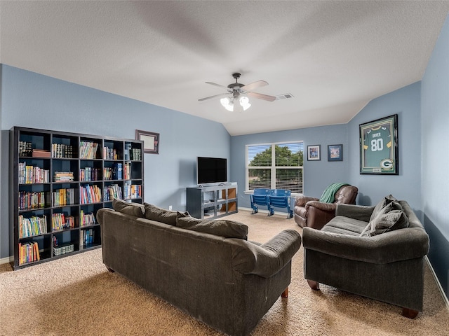 5732 Chateau Dr, Sachse, TX 75048 - carpeted living room with ceiling fan, vaulted ceiling, a textured ceiling, and baseboards