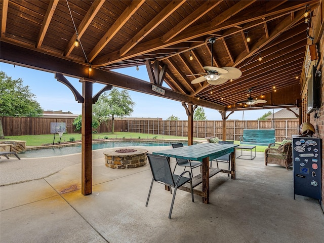5732 Chateau Dr, Sachse, TX 75048 - fenced backyard with a fire pit, a patio area, ceiling fan, and outdoor dining space