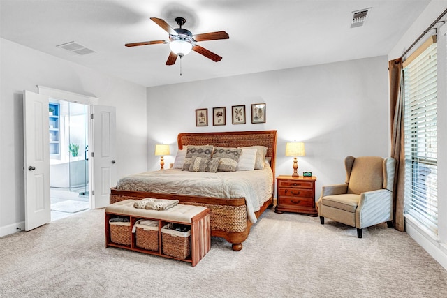 carpeted bedroom featuring a ceiling fan, visible vents, and multiple windows
