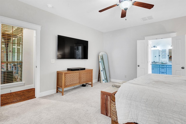 bedroom with connected bathroom, ceiling fan, light carpet, baseboards, and visible vents