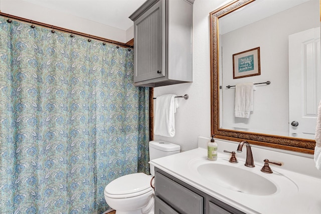 full bathroom with vanity, a shower with shower curtain, and toilet