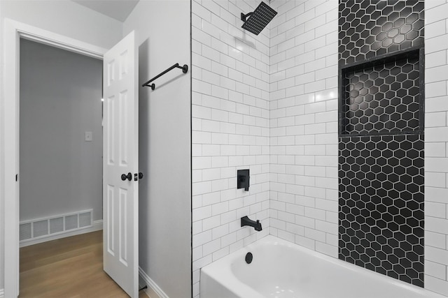 2708 Ash Park Dr, Richland Hills, TX 76118 - bathroom with washtub / shower combination, wood finished floors, and baseboards