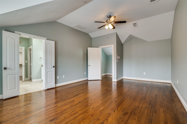 interior space with visible vents, a ceiling fan, wood finished floors, and vaulted ceiling