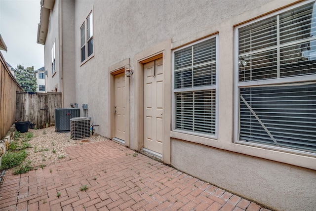 view of patio featuring central AC and fence