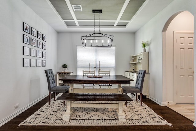 8480 Kincaid Ln, Frisco, TX 75036 - dining space featuring an inviting chandelier, arched walkways, wood finished floors, visible vents, and coffered ceiling