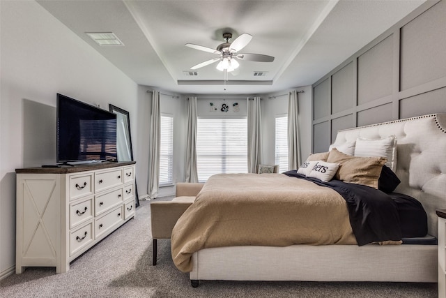 8480 Kincaid Ln, Frisco, TX 75036 - bedroom featuring a raised ceiling, light carpet, a ceiling fan, and visible vents
