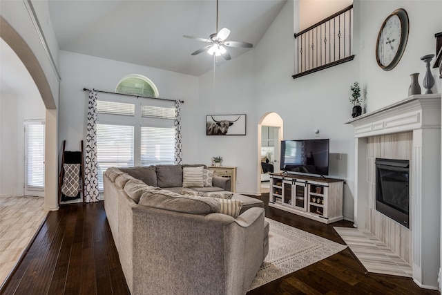 8480 Kincaid Ln, Frisco, TX 75036 - living area featuring a ceiling fan, arched walkways, a fireplace, hardwood / wood-style flooring, and high vaulted ceiling