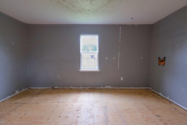 unfurnished room featuring a textured ceiling