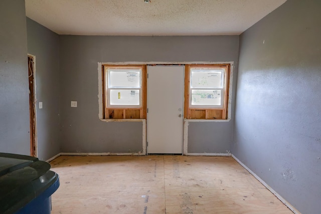 unfurnished room featuring baseboards