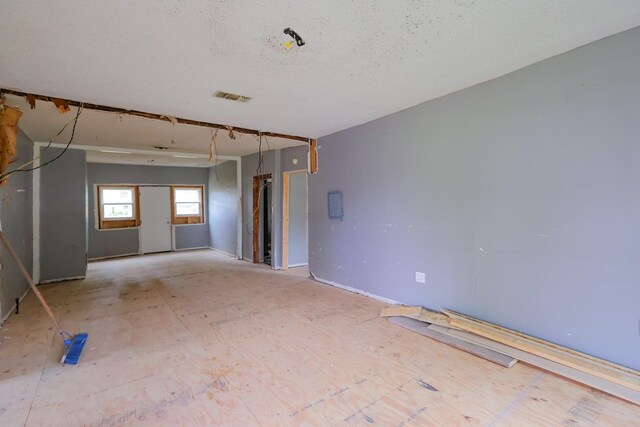 spare room featuring a textured ceiling and visible vents
