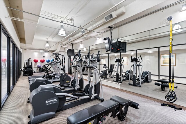3111 Welborn St Unit 1405, Dallas, TX 75219 - exercise room featuring visible vents and carpet