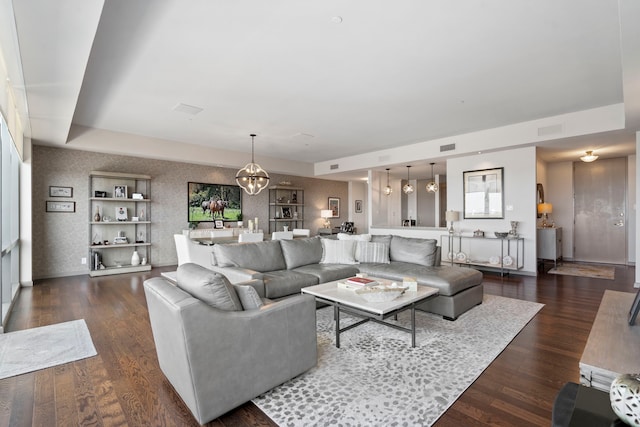 3111 Welborn St Unit 1405, Dallas, TX 75219 - living area featuring visible vents, baseboards, dark wood-style floors, a notable chandelier, and wallpapered walls