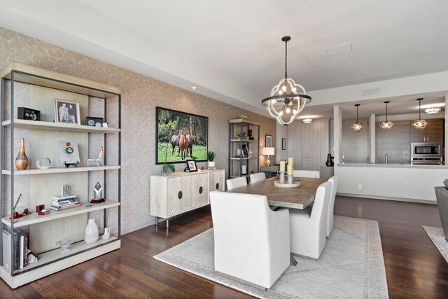 3111 Welborn St Unit 1405, Dallas, TX 75219 - dining room with an inviting chandelier, wood finished floors, and wallpapered walls