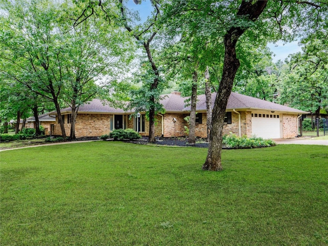 2345 Ravenwood Dr, Grand Prairie, TX 75050 - ranch-style home featuring an attached garage, concrete driveway, brick siding, and a front yard