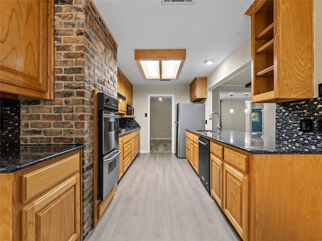 2345 Ravenwood Dr, Grand Prairie, TX 75050 - kitchen with light wood-style floors, a sink, decorative backsplash, and appliances with stainless steel finishes