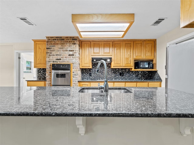 2345 Ravenwood Dr, Grand Prairie, TX 75050 - kitchen featuring stainless steel oven, a sink, visible vents, and black microwave