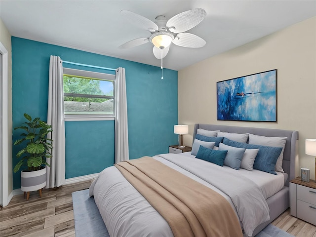 2345 Ravenwood Dr, Grand Prairie, TX 75050 - bedroom featuring light wood-type flooring, a ceiling fan, and baseboards