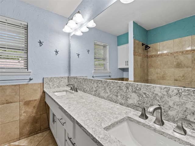 2345 Ravenwood Dr, Grand Prairie, TX 75050 - full bathroom featuring tile patterned flooring, a sink, a textured wall, and a tile shower