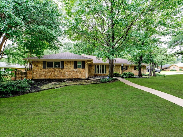 2345 Ravenwood Dr, Grand Prairie, TX 75050 - split level home with brick siding and a front yard