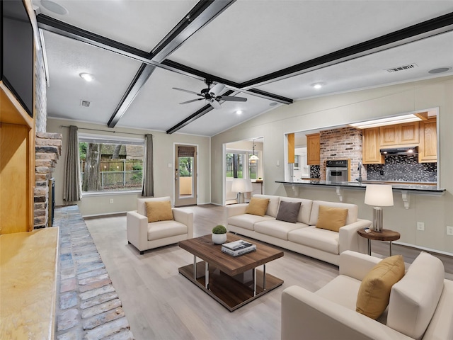 2345 Ravenwood Dr, Grand Prairie, TX 75050 - living room featuring ceiling fan, visible vents, baseboards, lofted ceiling with beams, and light wood-style floors