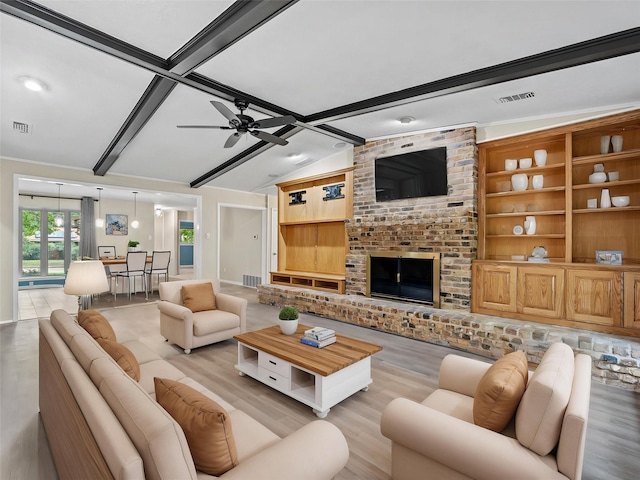 2345 Ravenwood Dr, Grand Prairie, TX 75050 - living room featuring a ceiling fan, visible vents, lofted ceiling with beams, and light wood-type flooring
