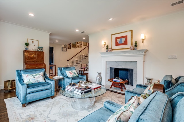 living area featuring recessed lighting, stairs, wood finished floors, and visible vents