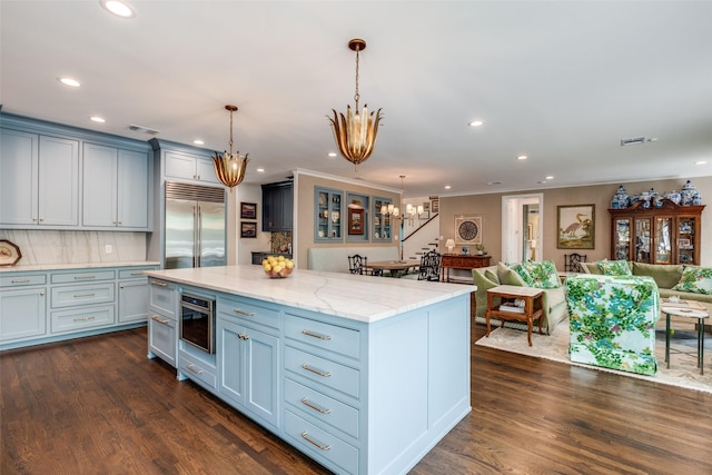 kitchen with visible vents, open floor plan, recessed lighting, built in refrigerator, and a notable chandelier