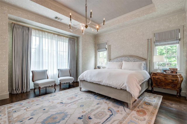 bedroom featuring visible vents, crown molding, wood finished floors, a notable chandelier, and wallpapered walls