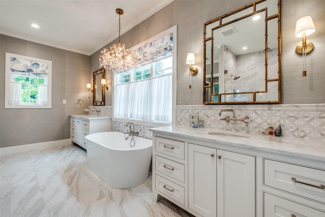 full bath with crown molding, two vanities, a sink, a walk in shower, and a soaking tub