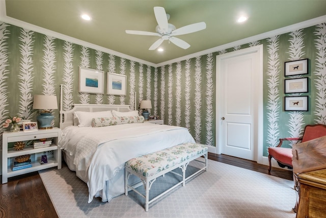 bedroom featuring ornamental molding, wood finished floors, and wallpapered walls