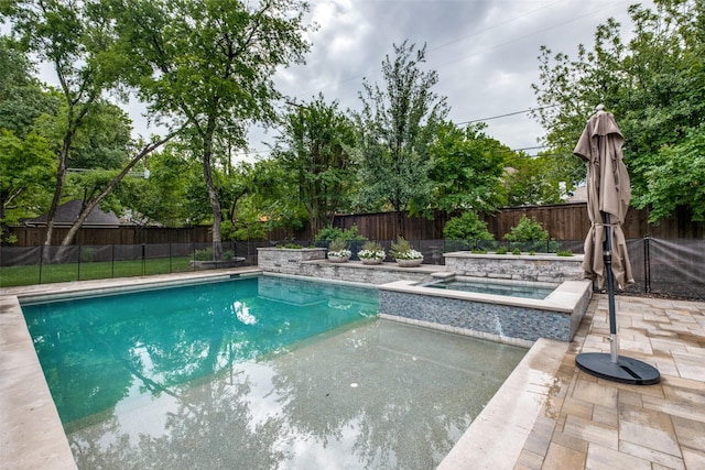 view of swimming pool with a fenced in pool, a fenced backyard, an in ground hot tub, and a patio